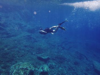 Young man scuba diving in sea