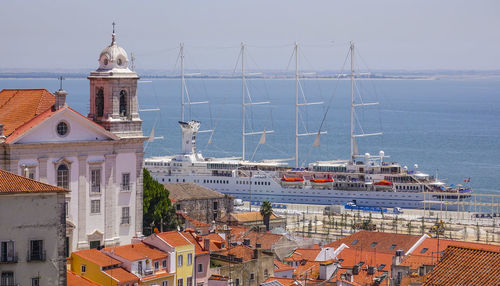 High angle view of buildings by sea against sky in city