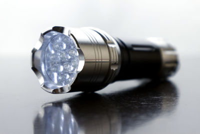 Close-up of light bulb on table