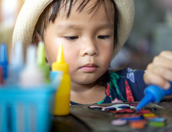 Close-up portrait of boy holding camera