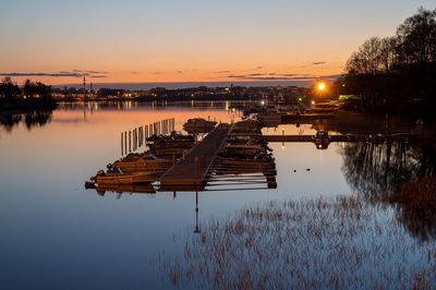 Beautiful dusk view of a leisure boat harbor casting reflections on the water.