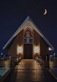 Illuminated building against sky at night