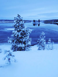 Scenic view of frozen lake against sky during winter