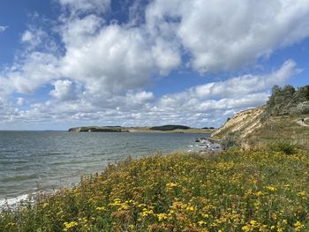 Scenic view of sea against cloudy sky