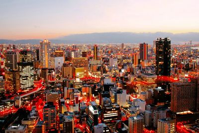 High angle view of illuminated city buildings against sky