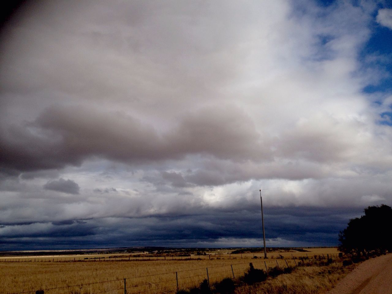 sky, tranquil scene, tranquility, cloud - sky, landscape, scenics, cloudy, beauty in nature, nature, field, cloud, weather, overcast, beach, horizon over land, sea, idyllic, remote, horizon over water, non-urban scene