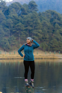 Rear view of woman standing in lake