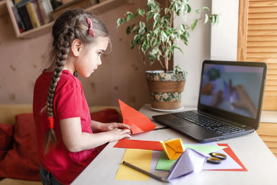 Cute girl doing craft at home