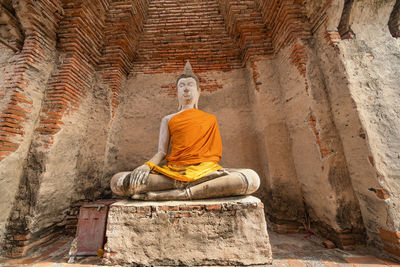 Statue of buddha against building