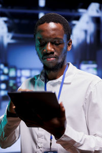 Portrait of young man using mobile phone