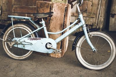 Old bicycle parked by wall