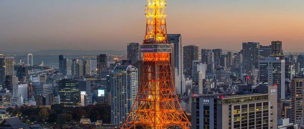 Skyscrapers in city at dusk