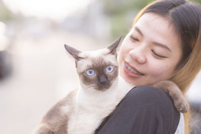 Portrait of woman with cat