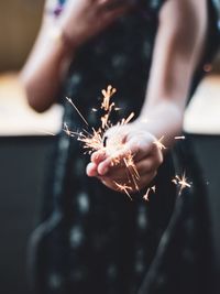 Close-up of hand holding sparkler