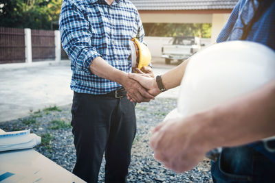 Midsection of man holding hands