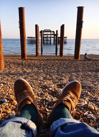 Low section of man relaxing on beach