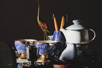 Close-up of lit candle against black background