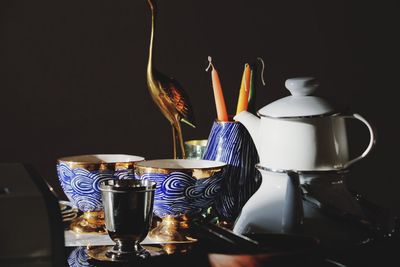 Close-up of lit candle against black background