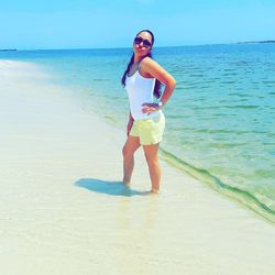 Full length of young woman standing on beach