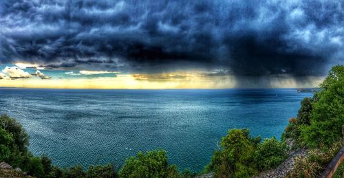 Scenic view of sea against storm clouds