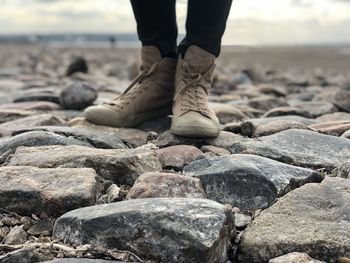 Low section of person standing on rocks