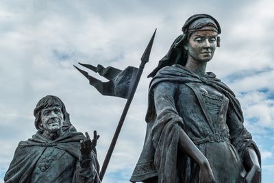 Low angle view of statue against sky