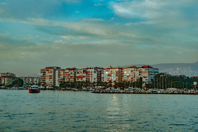 View of townscape by sea against sky