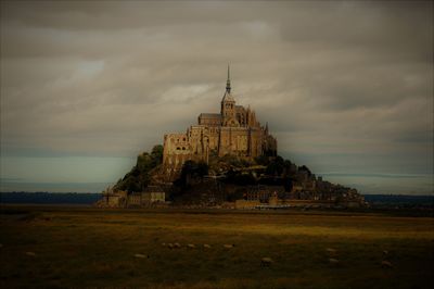 View of temple building against cloudy sky