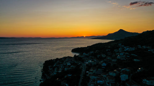 Scenic view of sea against orange sky