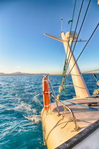 Sailboat in sea against clear sky