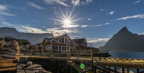 Low angle view of buildings by sea against sky