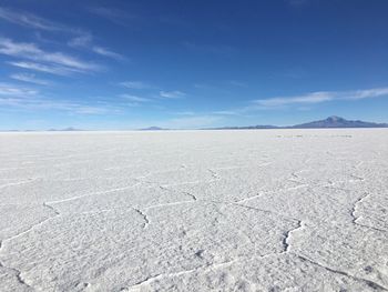 Scenic view of desert against blue sky