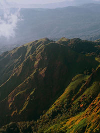 High angle view of land and mountains against sky