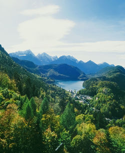 Scenic view of trees and mountains against sky