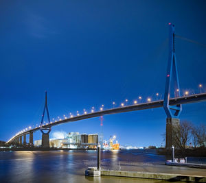 Suspension bridge over river at night