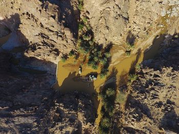 Aerial view of rock formations and shallow river during sunny day