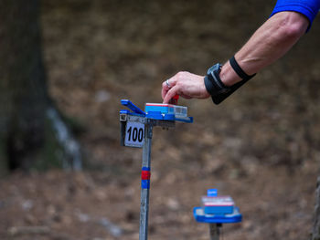 Orienteering in the forest. person hold map and searching the shortest way to target