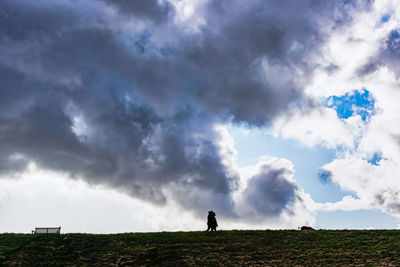 Person standing on field against sky