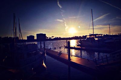 Boats in river at sunset