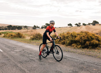 Man riding bicycle on field