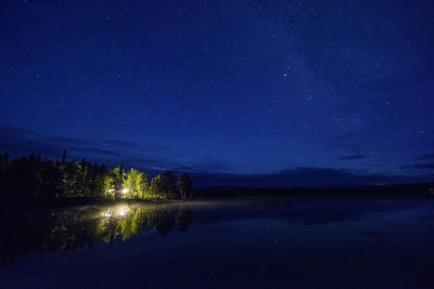 Scenic view of lake against star field at night