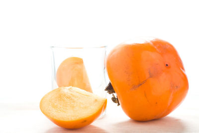 Close-up of persimmons over white background