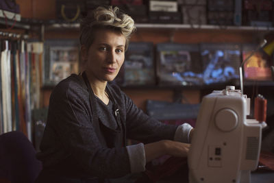 Portrait of confident female tailor in design studio