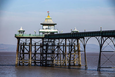 Pier over sea against sky during sunset