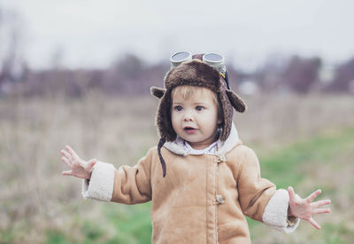 Portrait of cute girl standing on field