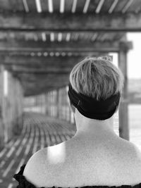 Rear view of woman sitting outdoors