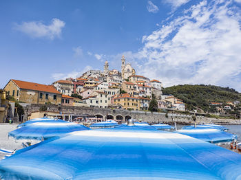 Buildings in city against blue sky