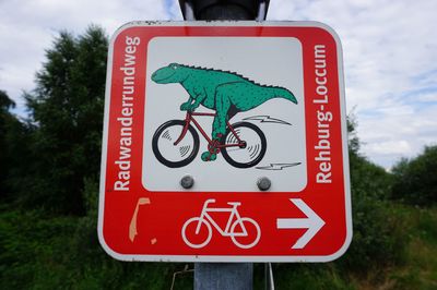 Close-up of road sign against trees