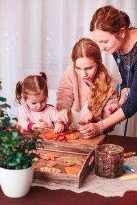 Family preparing gingerbread cookies at home