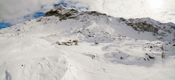 Scenic view of snow covered mountains against sky